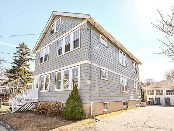 Front view of a two-story house with multiple windows.