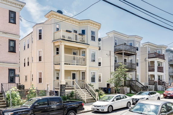 Front view of three multi-story residential buildings with balconies.