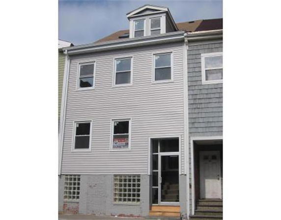 Front view of a three-story townhouse.