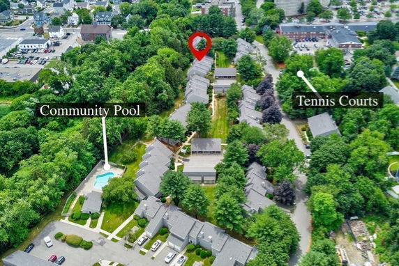 Aerial view of a residential complex with labeled community pool and tennis courts.
