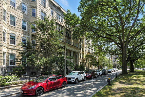 Front view of a multi-story residential building with brick exterior.