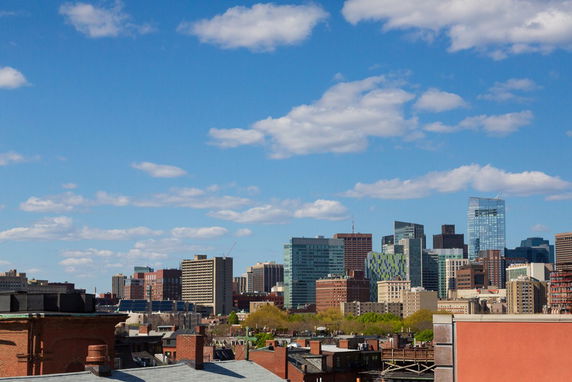 Panoramic view of a cityscape with skyscrapers and a clear blue sky.