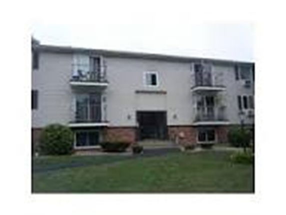 Front view of a two-story apartment building with balconies.