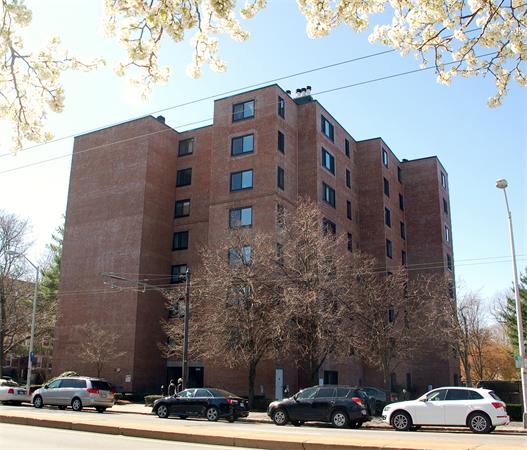 Front view of a multi-story brick apartment building.