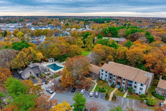 Panoramic view of residential buildings surrounded by autumn trees.