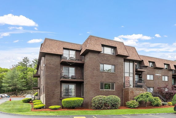 Front view of a multi-story brick residential building.
