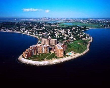 Panoramic view of a coastal residential complex on a peninsula.