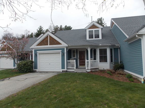 Front view of a house with a single garage and a small porch.