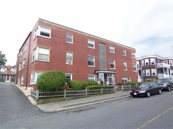 Front view of a three-story brick apartment building.