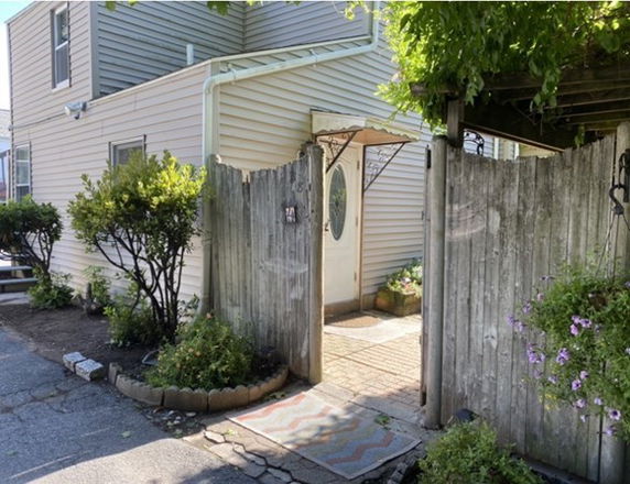 Front view of a two-story house with a garden entrance.
