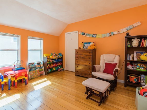 Indoor play area with colorful children's furniture and toys.