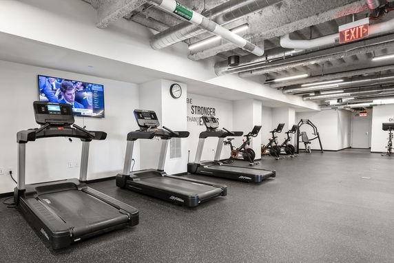 Indoor gym area with treadmills and exercise bikes.