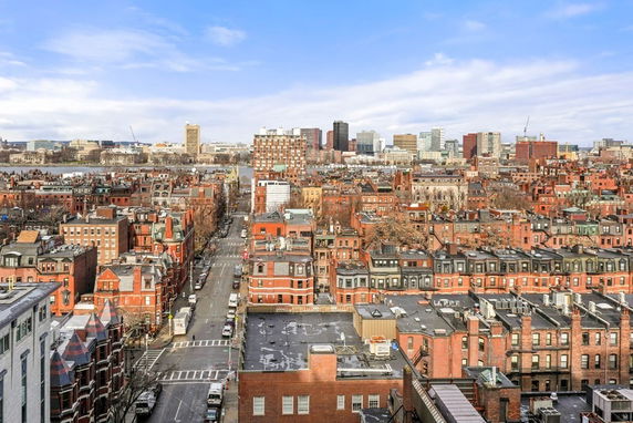 Panoramic view of a cityscape with numerous brick buildings and a skyline in the distance.