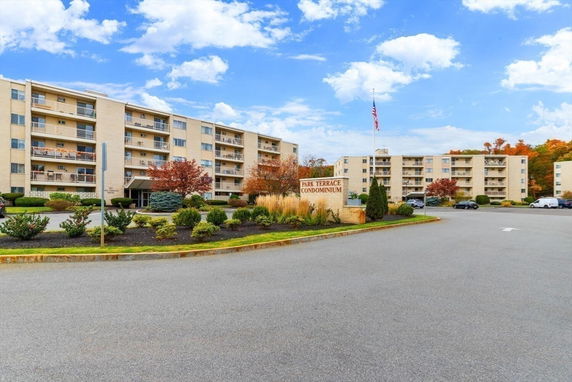 Front view of a multi-story condominium complex with balconies.