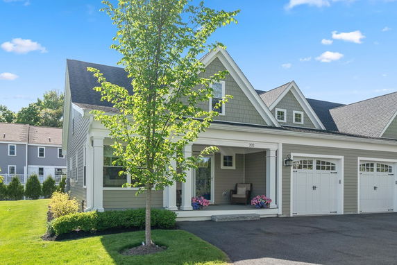 Front view of a house with a porch and double garage.