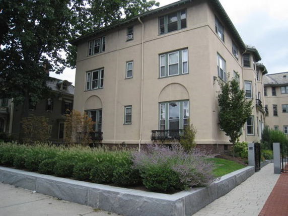 Front and side view of a multi-story residential building.