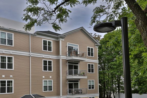 Front view of a multi-story apartment building with balconies.