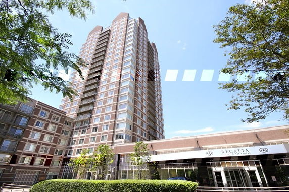 Front view of a high-rise residential building with multiple floors.