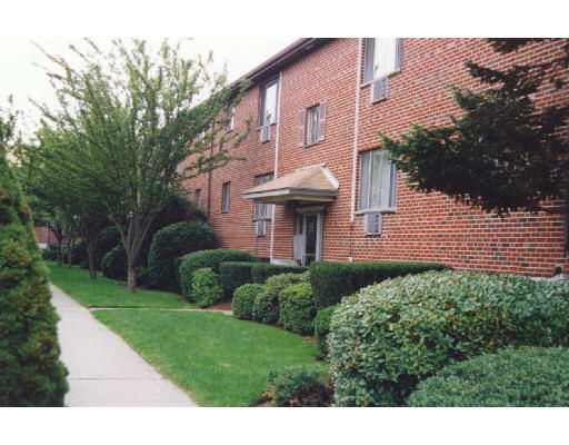 Front view of a brick multi-story building with a small entrance canopy.
