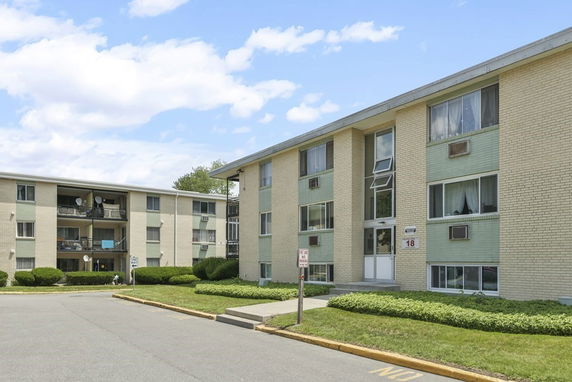Front view of a two-story apartment building with balconies.