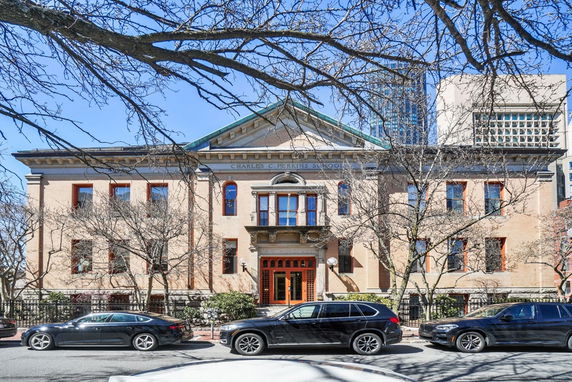 Front view of a historic building with symmetrical windows and a central entrance.