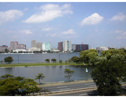 Panoramic view of a cityscape with buildings and water in the foreground.