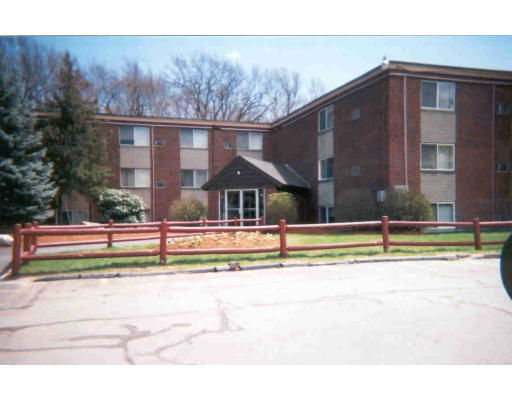 Front view of a multi-story brick apartment building.