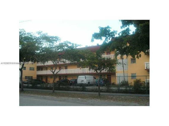 Front view of a multi-story building with balconies.