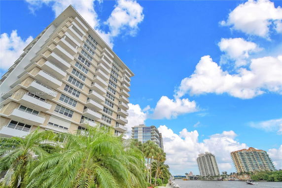 Front view of a high-rise residential building with multiple balconies.