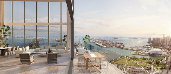 Panoramic view of a high-rise building with a cityscape and ocean in the background.