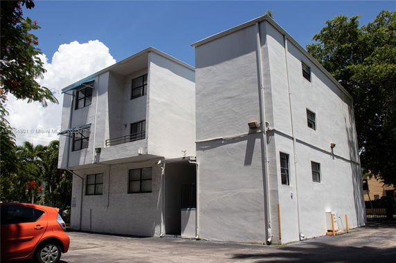 Front view of a multi-story building with balconies.