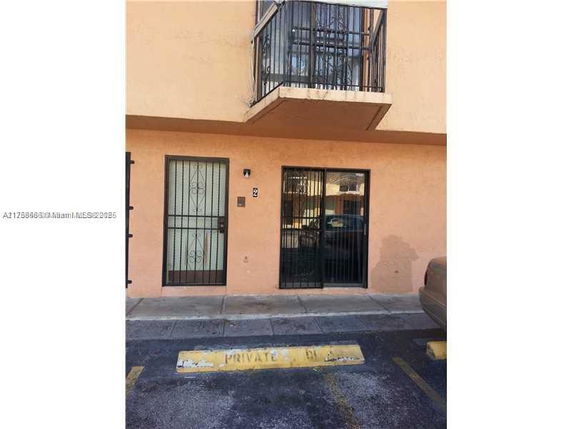 Front view of a building with a balcony and gated entrance.