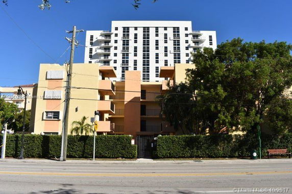 Front view of a multi-story residential building with balconies.