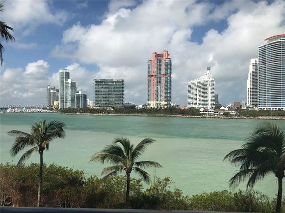 Skyline of high-rise buildings viewed from across a body of water.