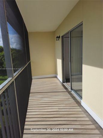 Balcony with railing wall and sliding glass door.