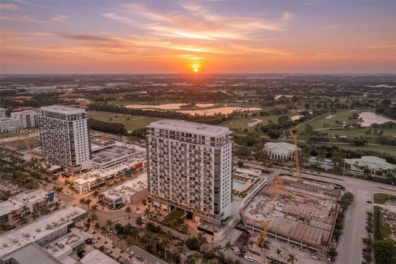 Panoramic view of high-rise buildings and surrounding area at sunset.