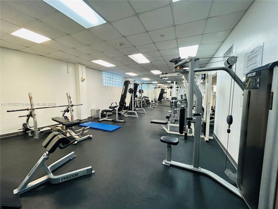 Indoor gym area with various exercise equipment.