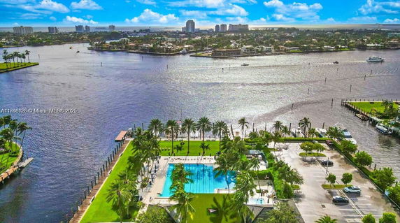 Panoramic view of a waterfront with a swimming pool and surrounding area.