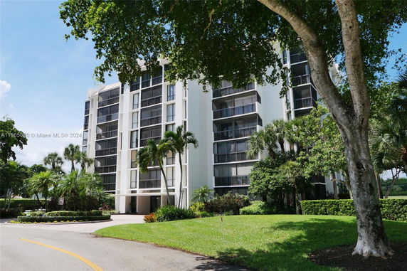 Front view of a multi-story residential building with balconies.
