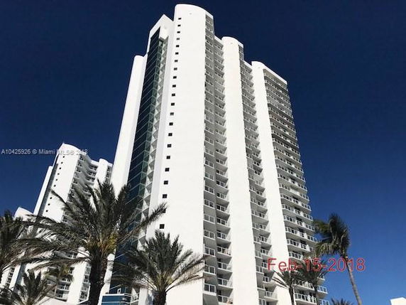 Elevated view of a high-rise building with multiple balconies.