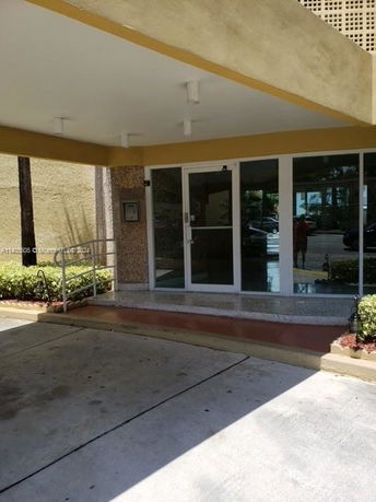 Front entrance of a building with a covered walkway.