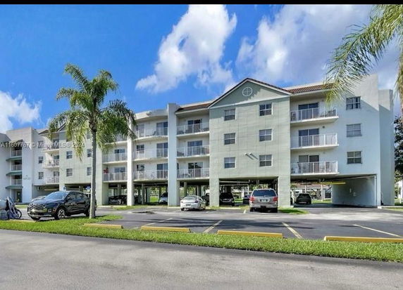 Front view of a multi-story apartment building with exterior balconies.