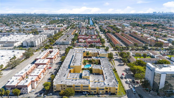 Aerial panoramic view of a residential and commercial area with buildings and streets.