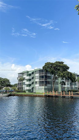 View of a waterfront apartment building with a dock.