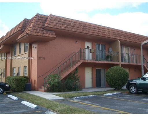 Front view of a two-story apartment building with external stairways.