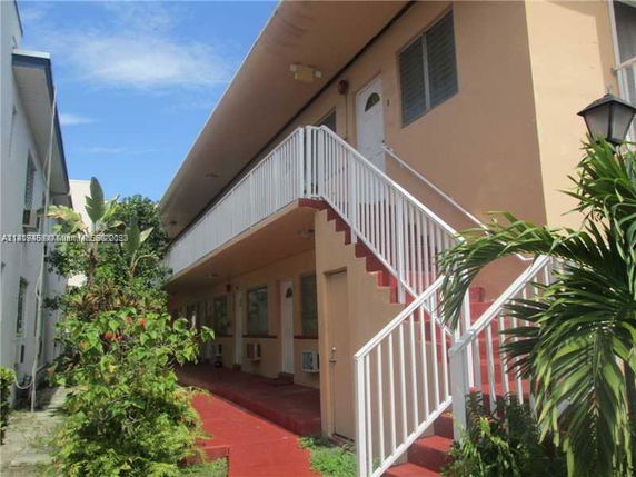 Front view of a two-story building with an external staircase.