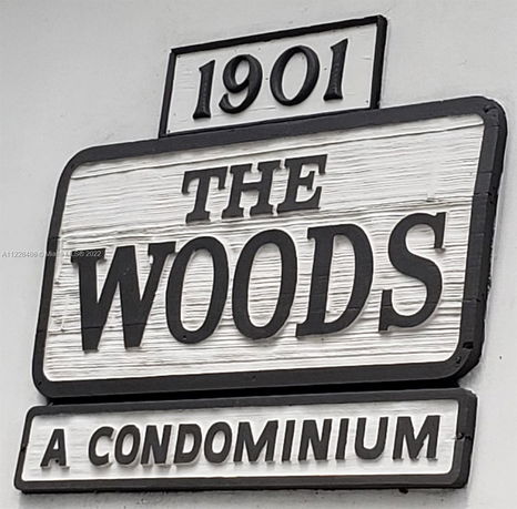 Signage for The Woods condominium.