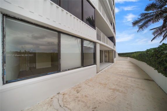 Exterior view of a multi-story building with large windows and balconies.