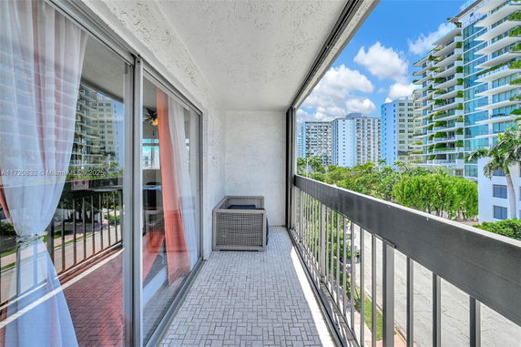 View from a balcony overlooking modern high-rise buildings.