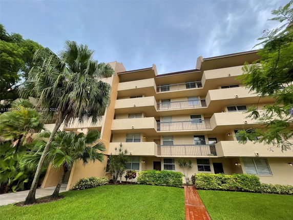 Front view of a multi-story apartment building with balconies.